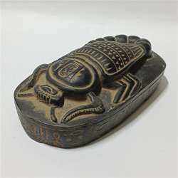 Ancient Egyptian scarab artifact style handmade stone carving with hieroglyphs
