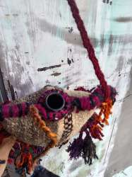 ?Handmade traditional Bedouin water flask with colorful handwoven wool details.