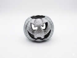 This is a decorative, shiny, silver-colored pumpkin-shaped lantern, designed to