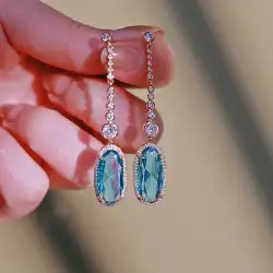 Elegant women's earrings in gold and silver studded with sky blue zircon stone