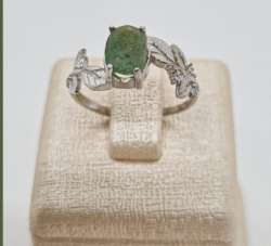 silver ring with a natural green emerald stone weighing 2.01 grams oval in shape
