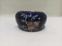 An antique Japanese porcelain tablecloth engraved with a gilded peacock pattern