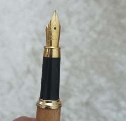 Two vintage antique pens, handcrafted wooden pieces in the shape of a feather