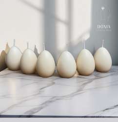 Six egg-shaped candles