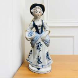 A porcelain statue of an elegant ancient woman in white  blue colors rose dress