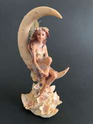 Vintage Figurine Of A Beautiful Girl with Wings Like Butterfly Sitting in Moon