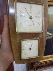 Antique wooden and metal weather station with thermometer and barometer