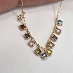 14K yellow gold bracelet adorned with vibrant multicolored stones, elegant charm