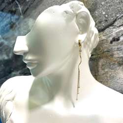 Elegant long 14K yellow gold earrings, graceful and charming.