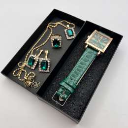 A complete gold jewelry set adorned with green stones, a perfect gift for women.