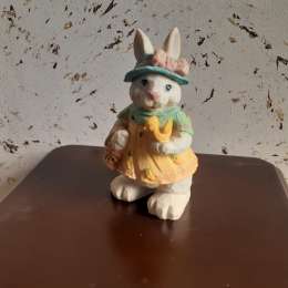 Mold of a rabbit holding a fruit basket and a bird