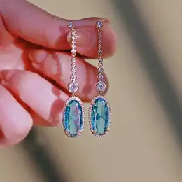 Elegant women's earrings in gold and silver studded with sky blue zircon stone