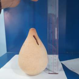 A beautiful clay money bank in the shape of a handmade vase for children