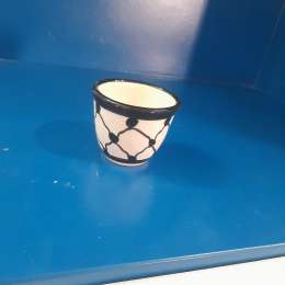 A cup colored with the Palestinian keffiyeh
