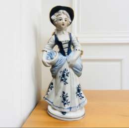 A porcelain statue of an elegant ancient woman in white  blue colors rose dress