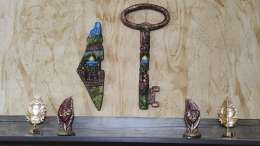 A statue of the Palestinian Key to Return and a Map of Palestine Made of Stone