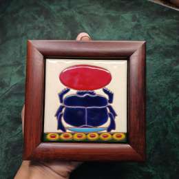 Ancient Egyptian porcelain wooden plaque in the shape of a pharaonic beetle