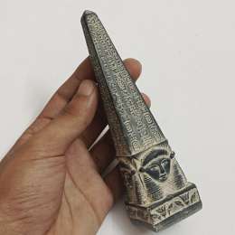 Egyptian-style obelisk statue with hieroglyphs and Hathor face carvings