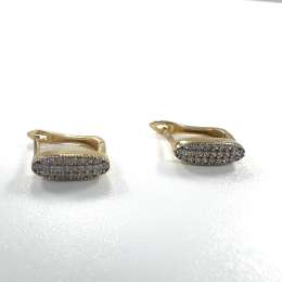 Elegant 14K yellow gold plug earrings with delicate design and sparkling zircon