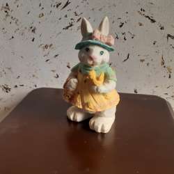 Mold of a rabbit holding a fruit basket and a bird